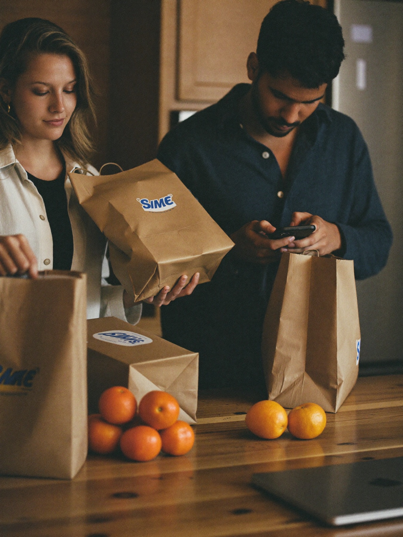 A couple unpacking groceries in their kitchen